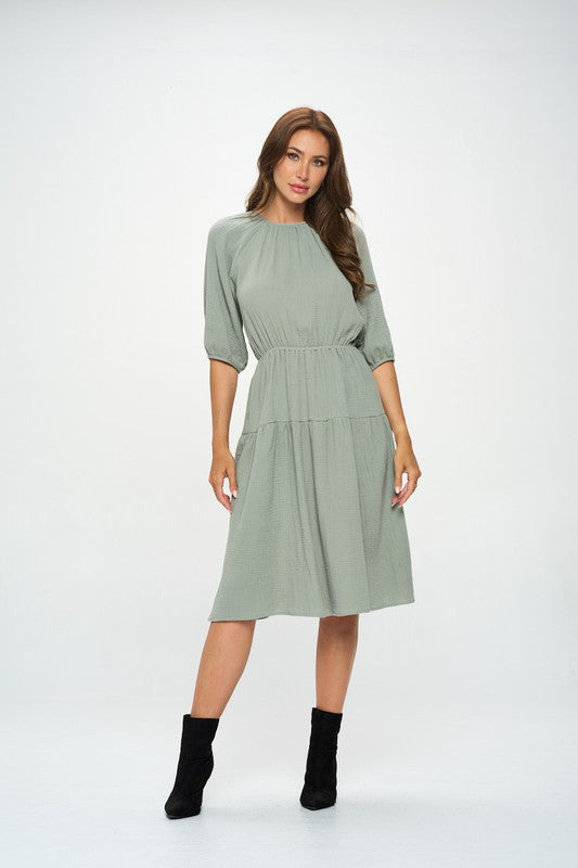 Women's textured gauze tiered midi dress with elastic waist and 3/4 puff sleeves.