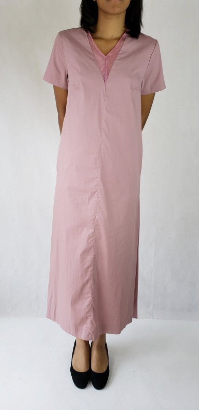 This maxi dress features dramatic long side slits and a flattering deep V-neck, accented by practical pockets for chic, effortless style.