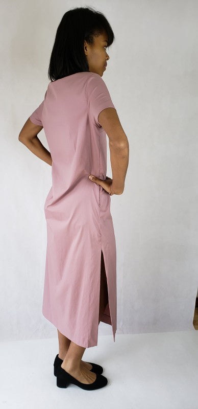 This maxi dress features dramatic long side slits and a flattering deep V-neck, accented by practical pockets for chic, effortless style.