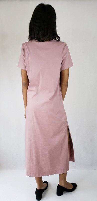 This maxi dress features dramatic long side slits and a flattering deep V-neck, accented by practical pockets for chic, effortless style.