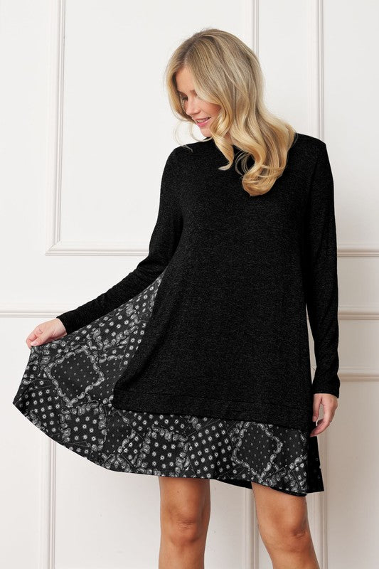 Women's long sleeve tunic top with bandana print layered hem and soft knit fabric.