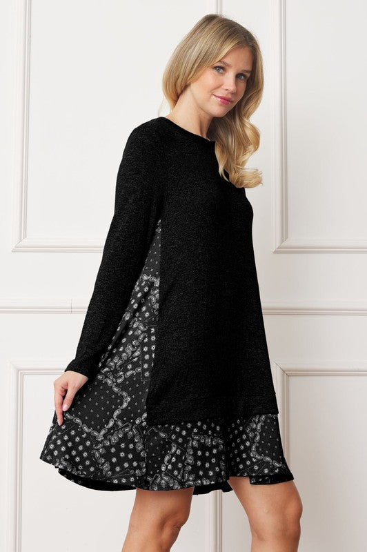 Women's long sleeve tunic top with bandana print layered hem and soft knit fabric.