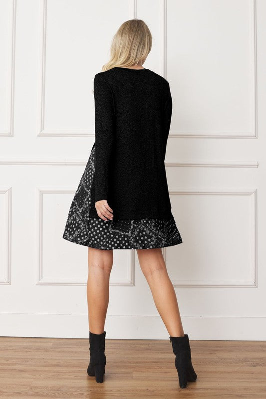 Women's long sleeve tunic top with bandana print layered hem and soft knit fabric.
