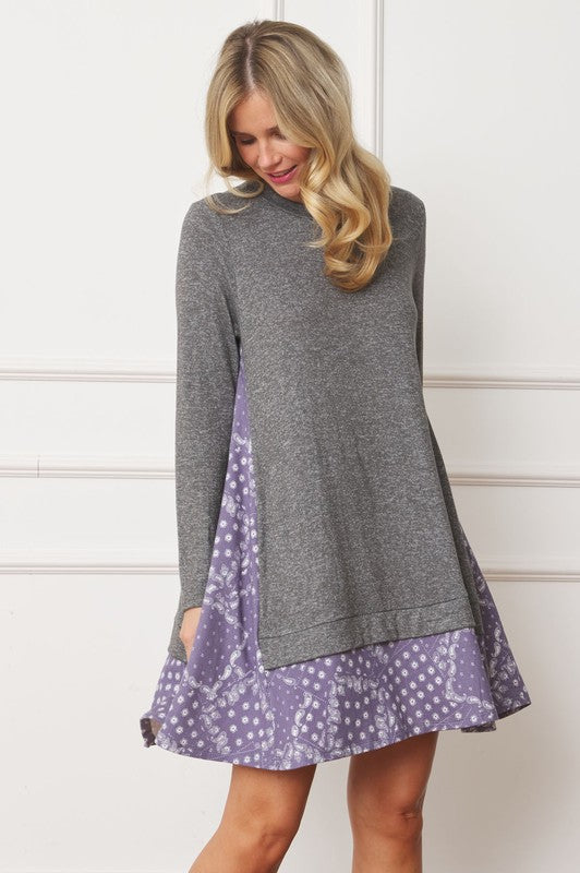 Women's long sleeve tunic top with bandana print layered hem and soft knit fabric.