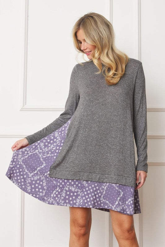 Women's long sleeve tunic top with bandana print layered hem and soft knit fabric.