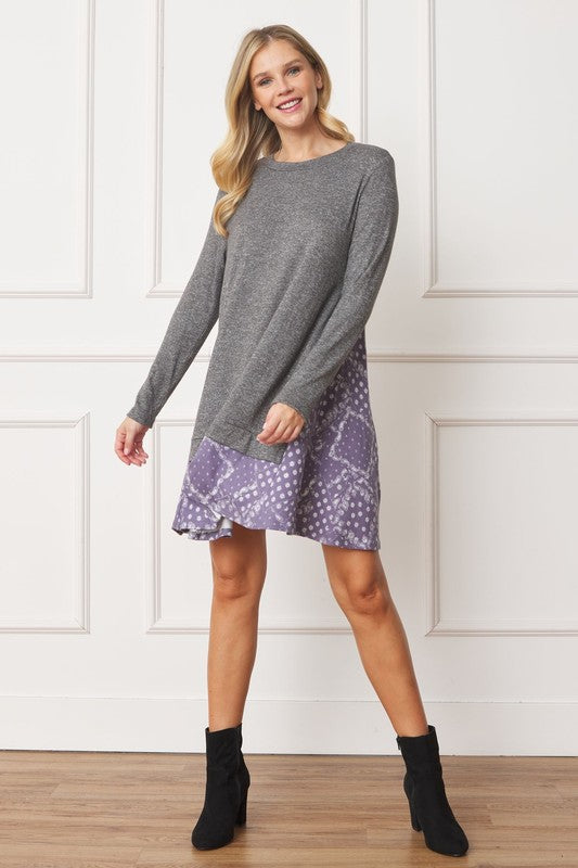 Women's long sleeve tunic top with bandana print layered hem and soft knit fabric.