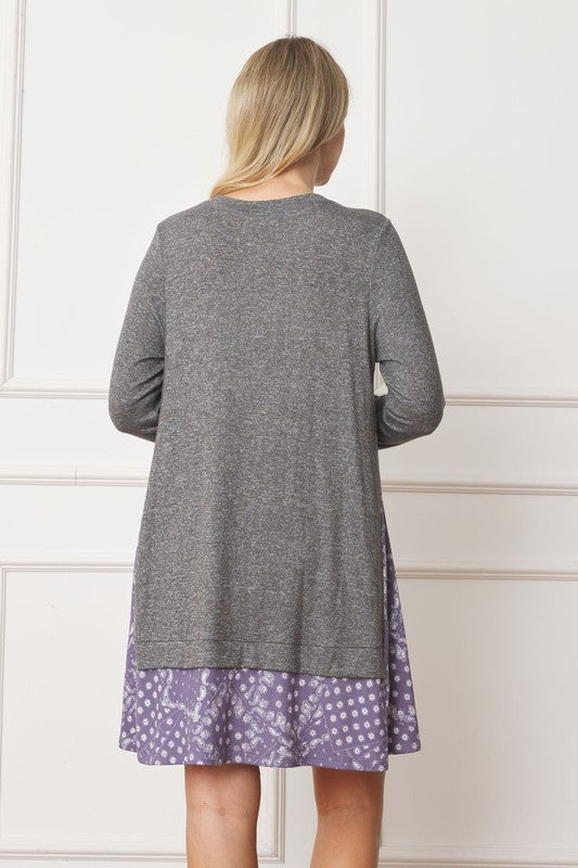 Women's long sleeve tunic top with bandana print layered hem and soft knit fabric.