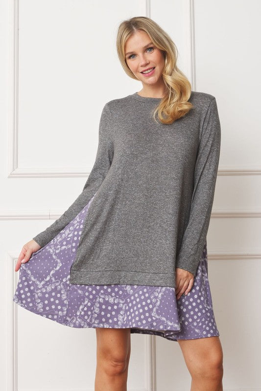 Women's long sleeve tunic top with bandana print layered hem and soft knit fabric.