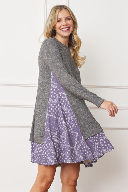 Women's long sleeve tunic top with bandana print layered hem and soft knit fabric.