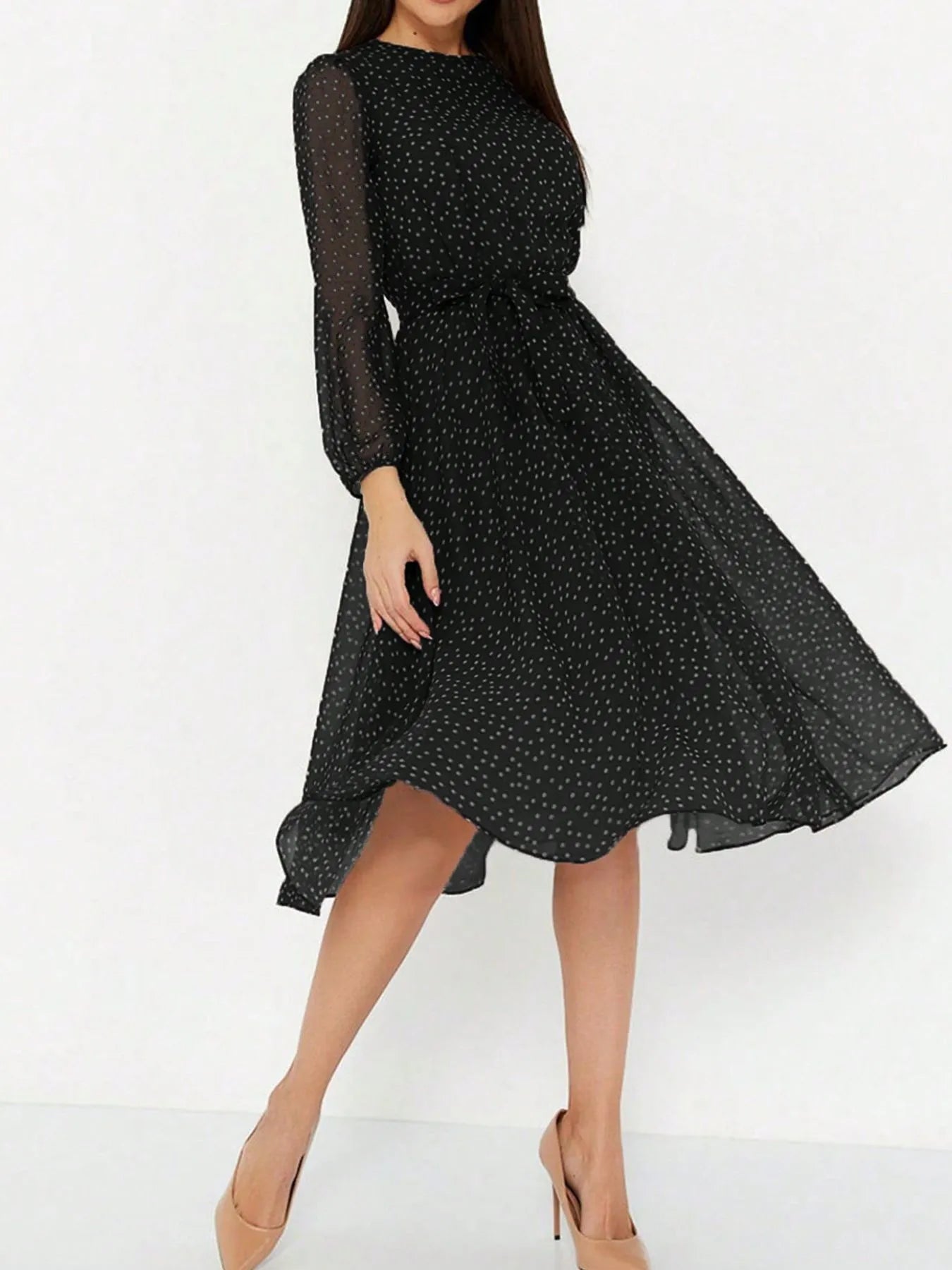Women's chiffon midi dress with polka dot print, sheer long sleeves, and a flowy skirt.