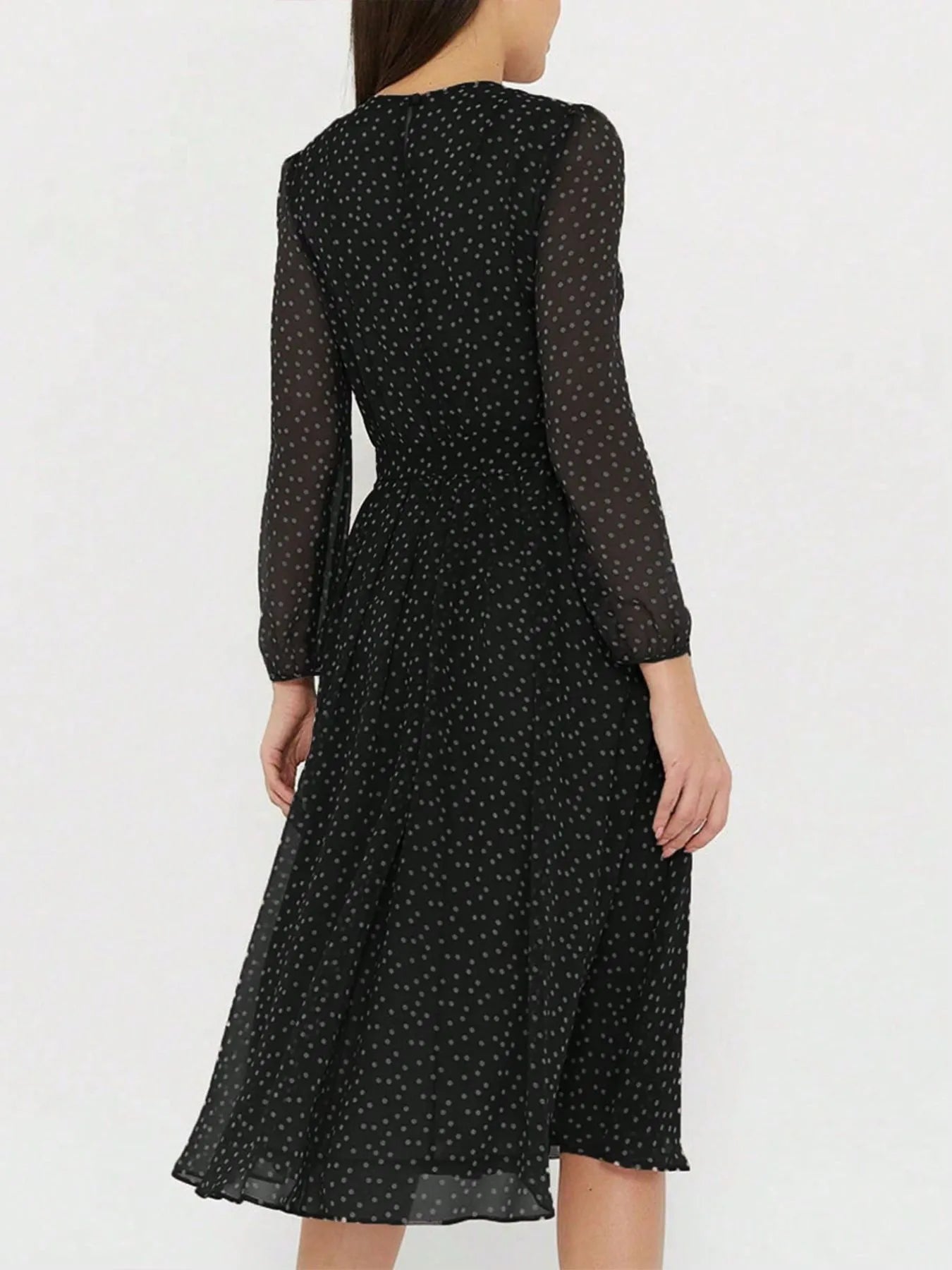 Women's chiffon midi dress with polka dot print, sheer long sleeves, and a flowy skirt.