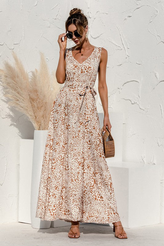 The tie-detail maxi dress features a flowing silhouette accentuated by adjustable tie details at the bodice and waist, creating a flattering, breezy look perfect for warm-weather occasions.