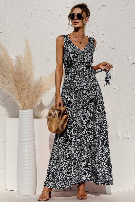The tie-detail maxi dress features a flowing silhouette accentuated by adjustable tie details at the bodice and waist, creating a flattering, breezy look perfect for warm-weather occasions.
