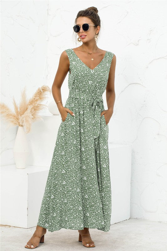 he tie-detail maxi dress features a flowing silhouette accentuated by adjustable tie details at the bodice and waist, creating a flattering, breezy look perfect for warm-weather occasions.