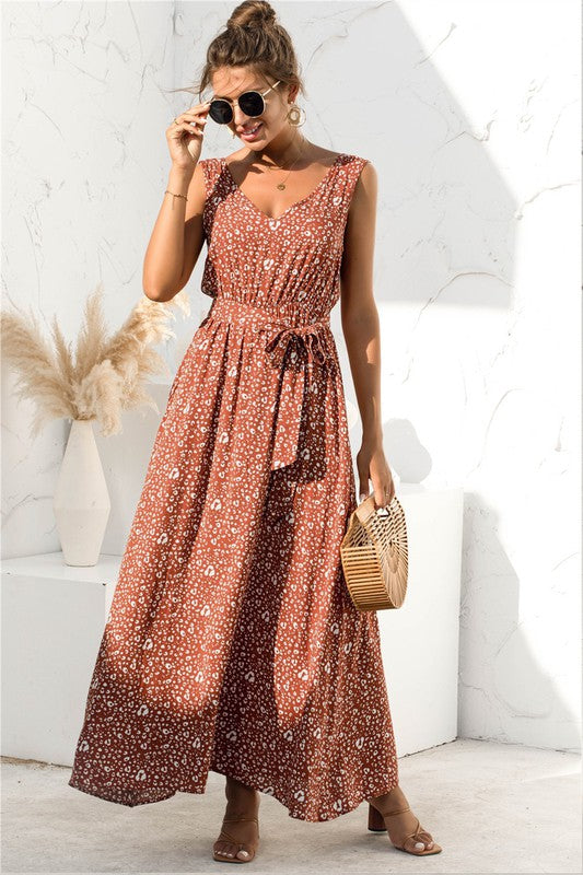 The tie-detail maxi dress features a flowing silhouette accentuated by adjustable tie details at the bodice and waist, creating a flattering, breezy look perfect for warm-weather occasions.