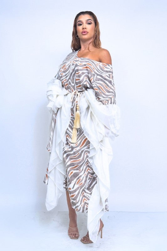 The Wild Dreams Flowing Maxi Dress is a breezy, ethereal gown featuring a fluid silhouette, soft drape, and dreamy, movement-friendly fabric that cascades to a graceful ankle-skimming hem.