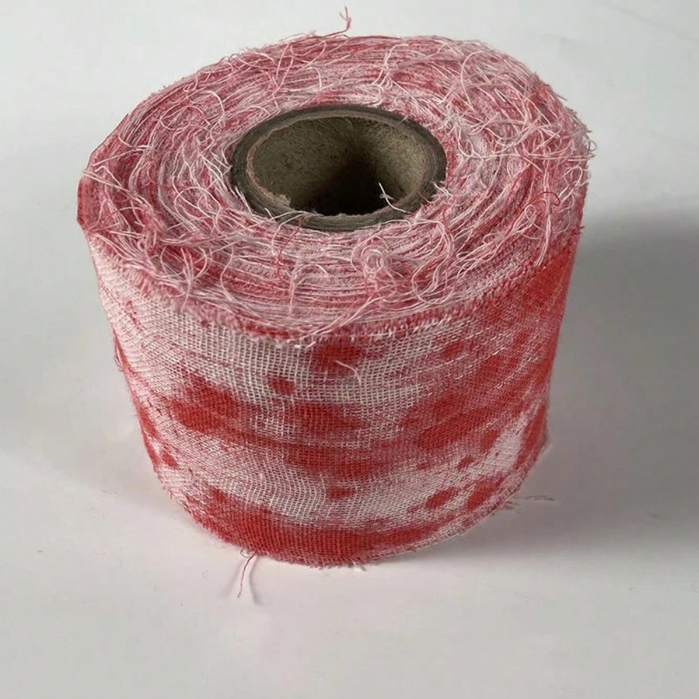 A roll of toilet paper designed to look like blood-stained gauze, likely for Halloween or horror-themed decor.