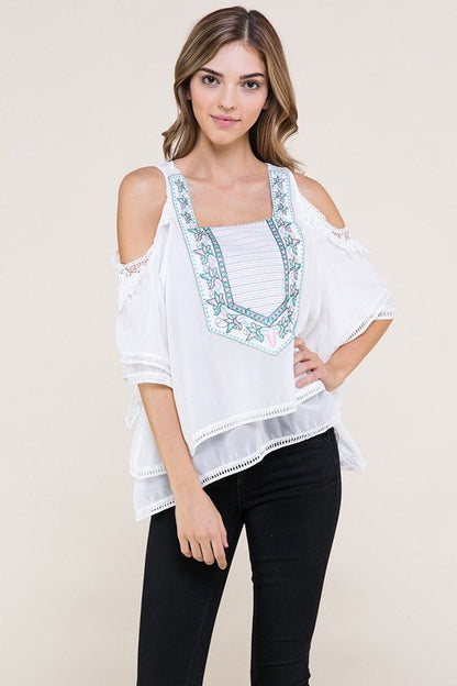 White fashion top with light blue and pink design