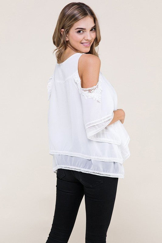 White fashion top with light blue and pink design