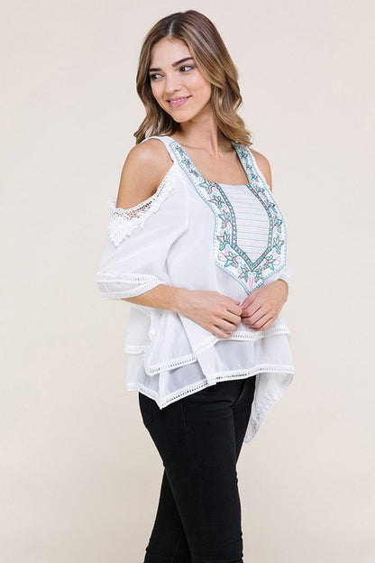 White fashion top with light blue and pink design