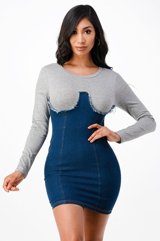 The dress is a form-fitting, color-block mini dress with a light gray long-sleeve top seamlessly blending into a dark blue denim-like bodice and skirt, creating a chic, body-skimming silhouette.