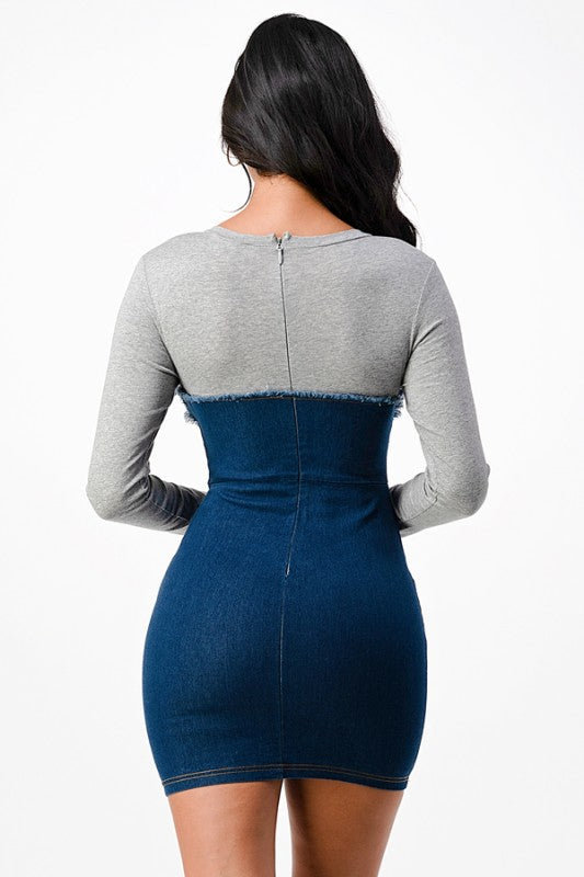 The dress is a form-fitting, color-block mini dress with a light gray long-sleeve top seamlessly blending into a dark blue denim-like bodice and skirt, creating a chic, body-skimming silhouette.
