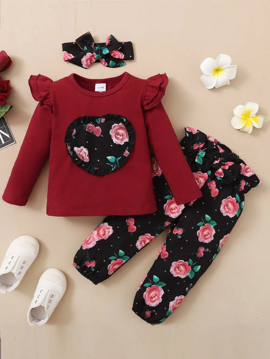 Baby girl outfit set in maroon with floral print top, coordinating bottoms, and headband

