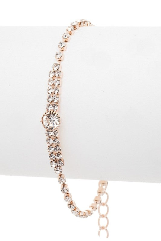 Elegant bracelet with intricate looped designs and a central gemstone, perfect for formal occasions or gifting.