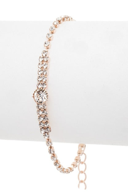 Elegant bracelet with intricate looped designs and a central gemstone, perfect for formal occasions or gifting.