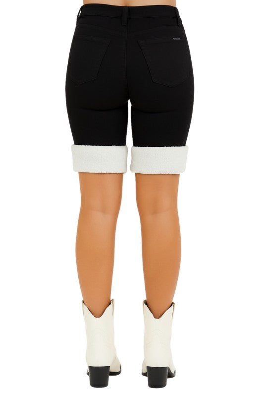 Bold denim meets cozy detail. These black denim capri shorts are designed to turn heads with their unique sherpa-trimmed cuffs and sleek silhouette. Whether you're headed to a rodeo, concert, or just want to elevate your everyday look, these shorts deliver standout style with comfort built in.