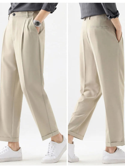 Beige pants worn by a person on a white background