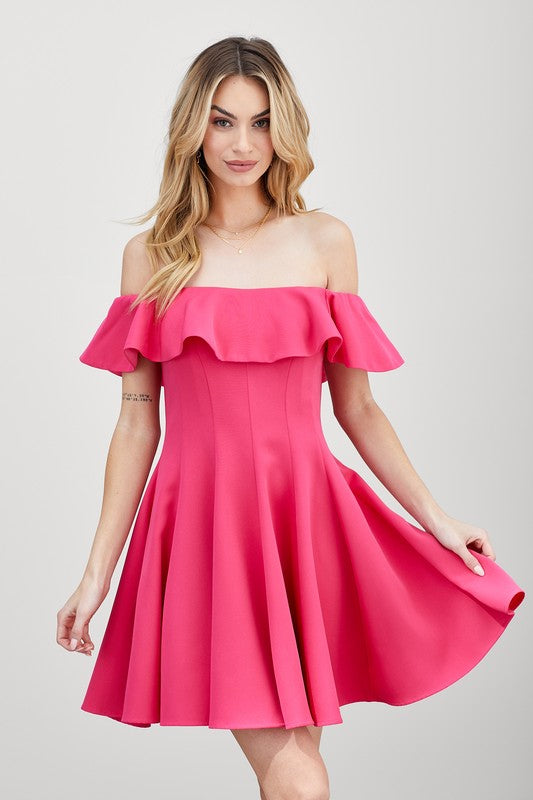 The dress is a short, off-the-shoulder pink frock with a dramatic ruffled neckline and a flared, A-line skirt.