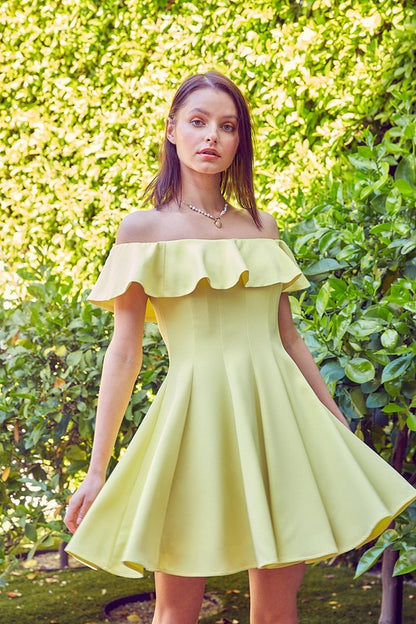 the dress is a short, off-the-shoulder pink frock with a dramatic ruffled neckline and a flared, A-line skirt
