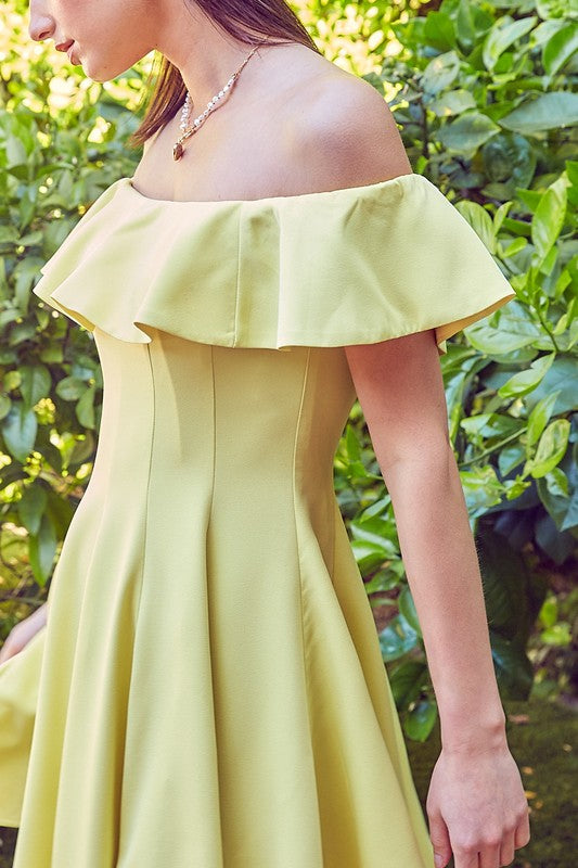 the dress is a short, off-the-shoulder light green frock with a dramatic ruffled neckline and a flared, A-line skirt
