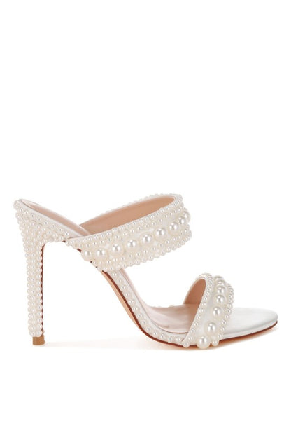 White high-heeled sandal with pearl embellishments on a white background