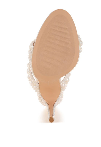 sole of pearl embellished sho with lace trim on a white background