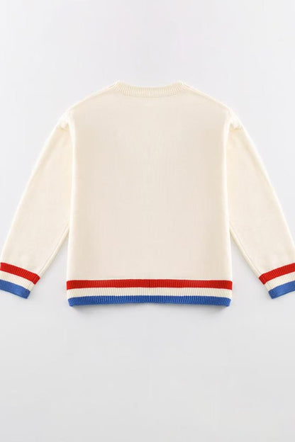 Beige sweater with red and blue stripes on a light gray background