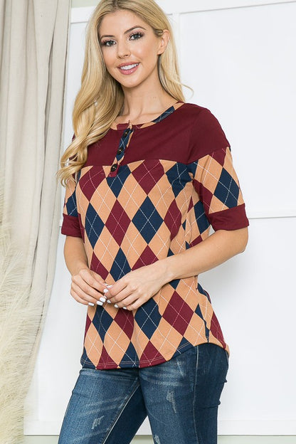 Soft knit jersey body elevated by a bold argyle pattern and front buttons.