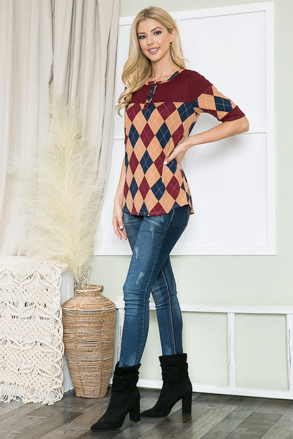 A flattering top with argyle accents and a sleek button-down look.