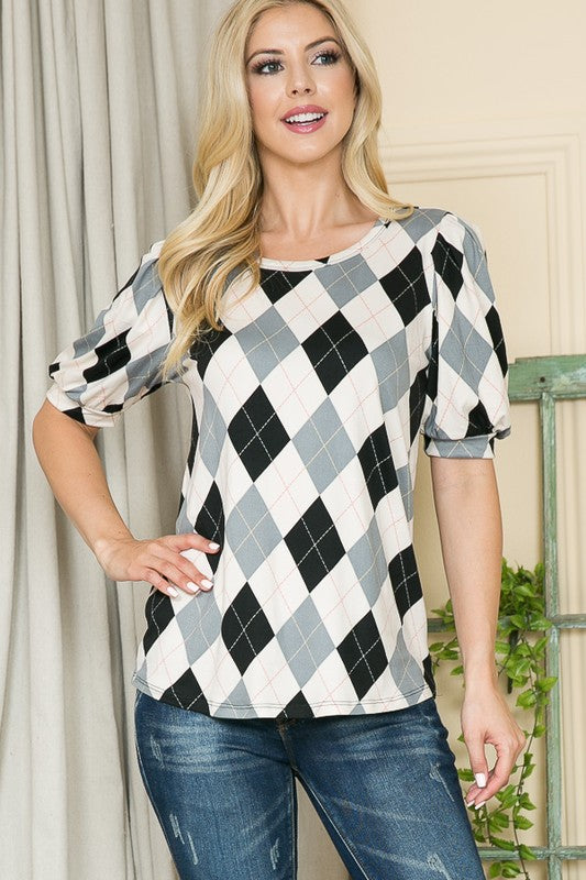 Bold argyle knit meets puff sleeves for a playful yet polished look.