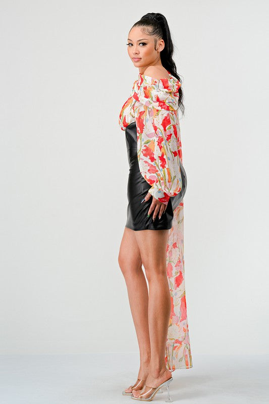 a woman in a black leather mini skirt and a floral print off-the-shoulder top with dramatic sleeves.
