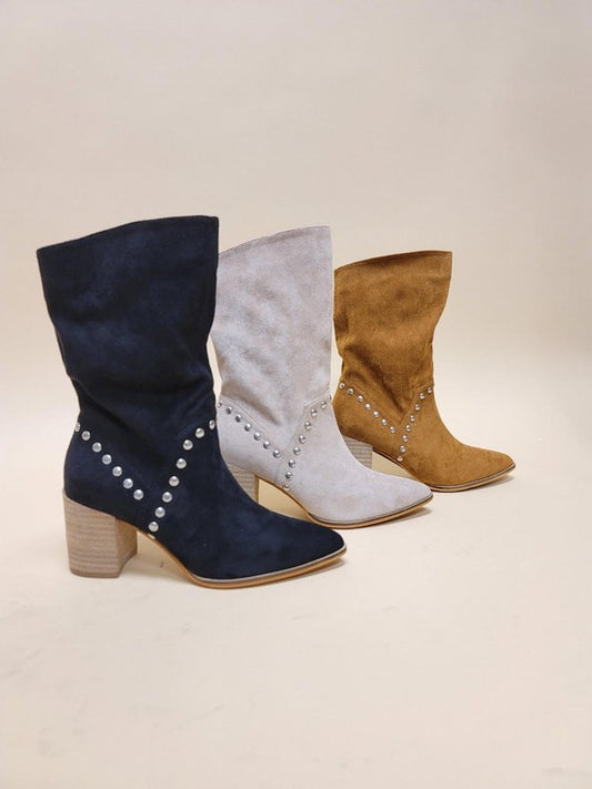 Slouchy knee-high boots in suede featuring metal stud trim, pointed toe silhouette, and chunky stacked heel design