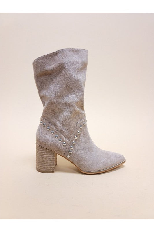 Slouchy knee-high boots in suede featuring metal stud trim, pointed toe silhouette, and chunky stacked heel design