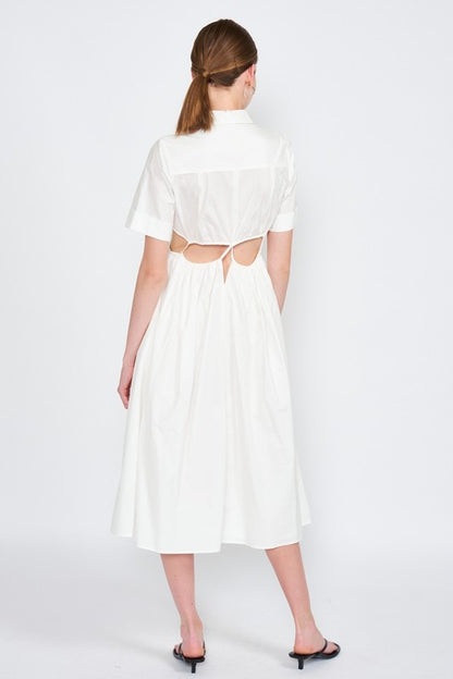Woman models a white midi dress with a collar, short sleeves, and trendy cut-out details, back view.