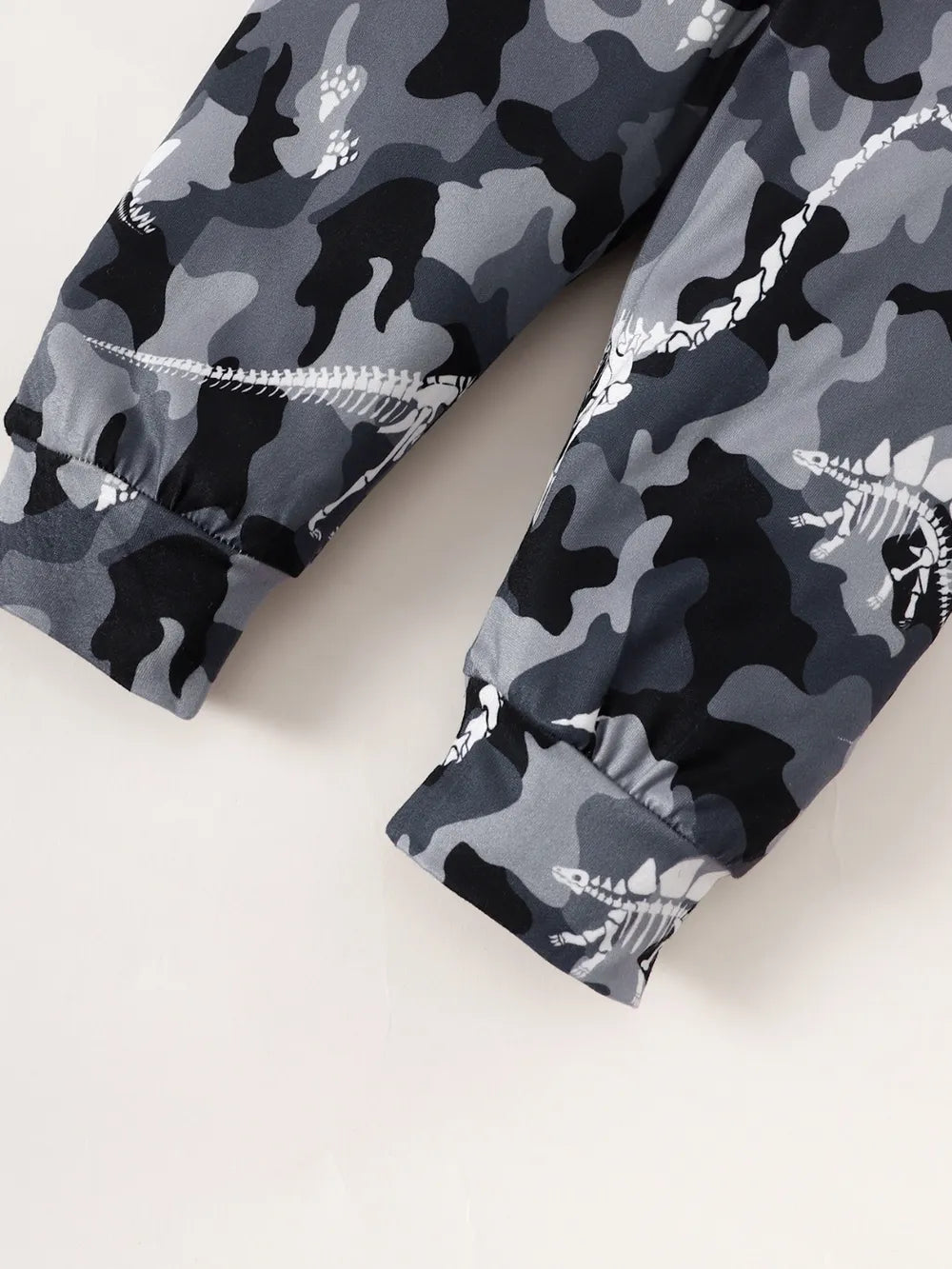 Gray camouflage pants with white accents on a light background