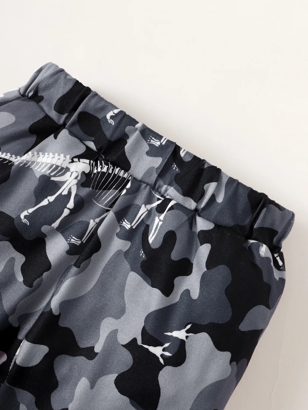 Camouflage-patterned shorts with a skeleton design on a white background