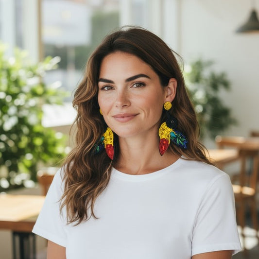 Woman wearing a plain white t-shirt and vibrant, multicolored statement earrings with a tropical-inspired design, bold, artistic, and perfect for adding flair to a casual look.