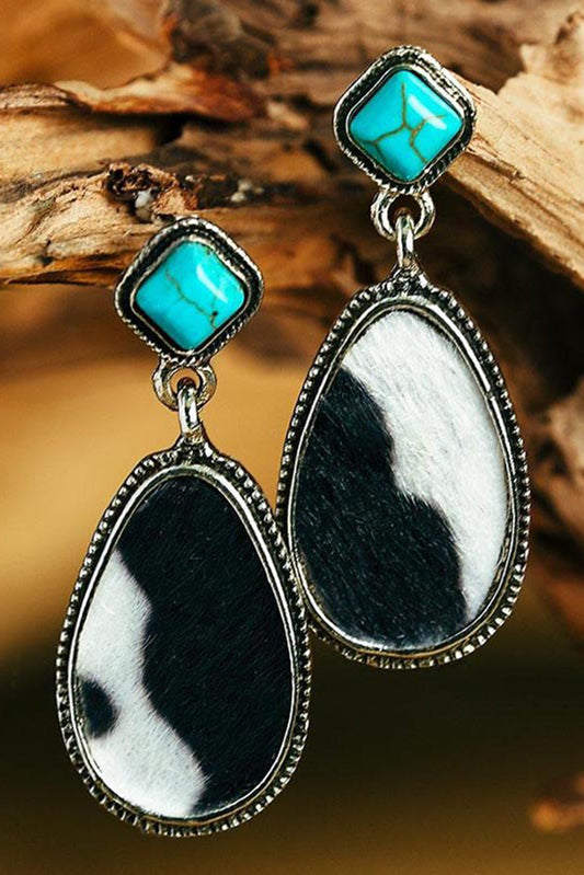 Western charm meets modern sass. These drop earrings are a bold blend of rustic flair and playful elegance. Featuring a striking black cow print paired with a pop of turquoise, they’re the kind of accessory that makes people say, “Where did you get those?”