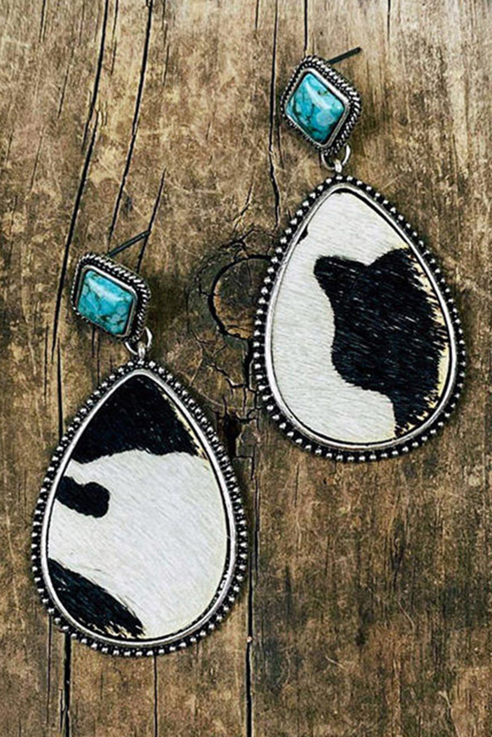 Western charm meets modern sass. These drop earrings are a bold blend of rustic flair and playful elegance. Featuring a striking black cow print paired with a pop of turquoise, they’re the kind of accessory that makes people say, “Where did you get those?”