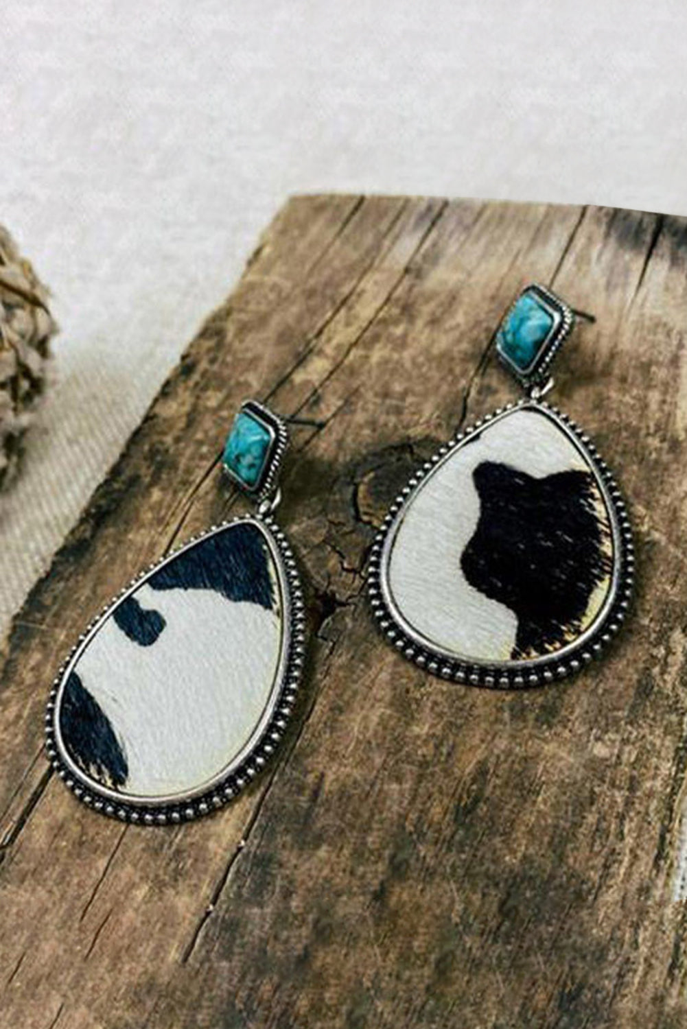 Western charm meets modern sass. These drop earrings are a bold blend of rustic flair and playful elegance. Featuring a striking black cow print paired with a pop of turquoise, they’re the kind of accessory that makes people say, “Where did you get those?”
